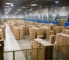 Warehouse full of stacked cardboard boxes.