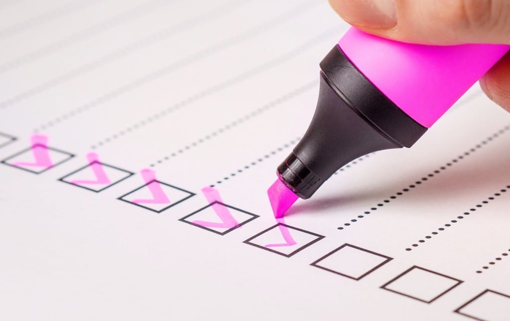 Person checking checkboxes on a checklist - Holder's Pest Solutions Service Houston, TX